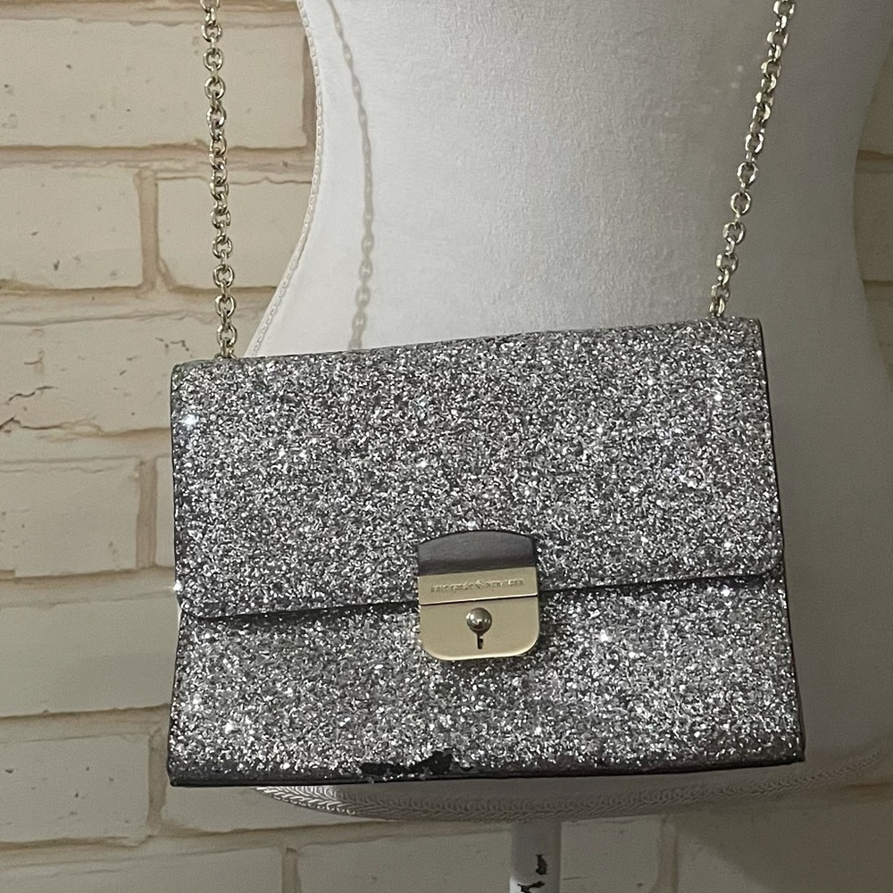 Kate spade squint purse with silver detailing.